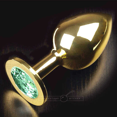 Анальная пробка большая с круглым кончиком и светло-зеленым кристаллом, золотистая